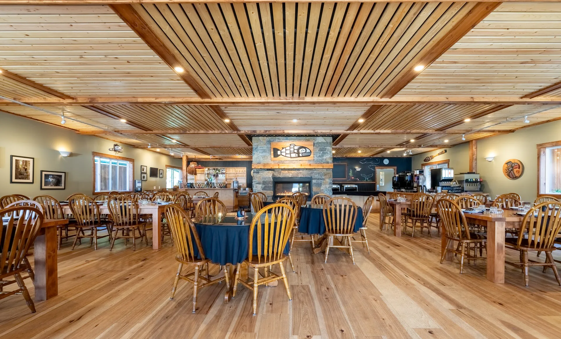 The dining room, timber ceiling, tables set with blue cloths