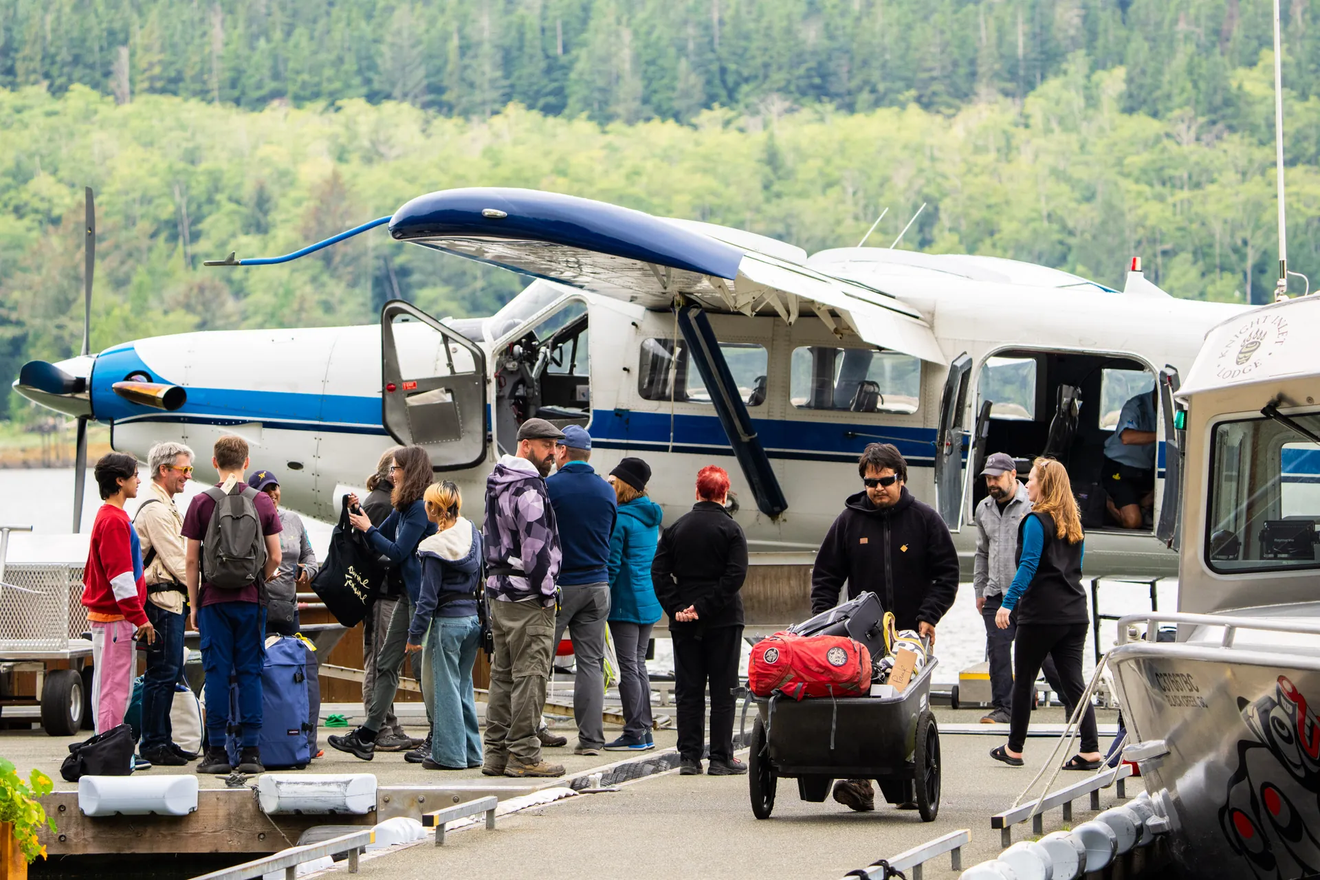 The floatplane on the Campbell River dock, guests and a luggage cart alongside
