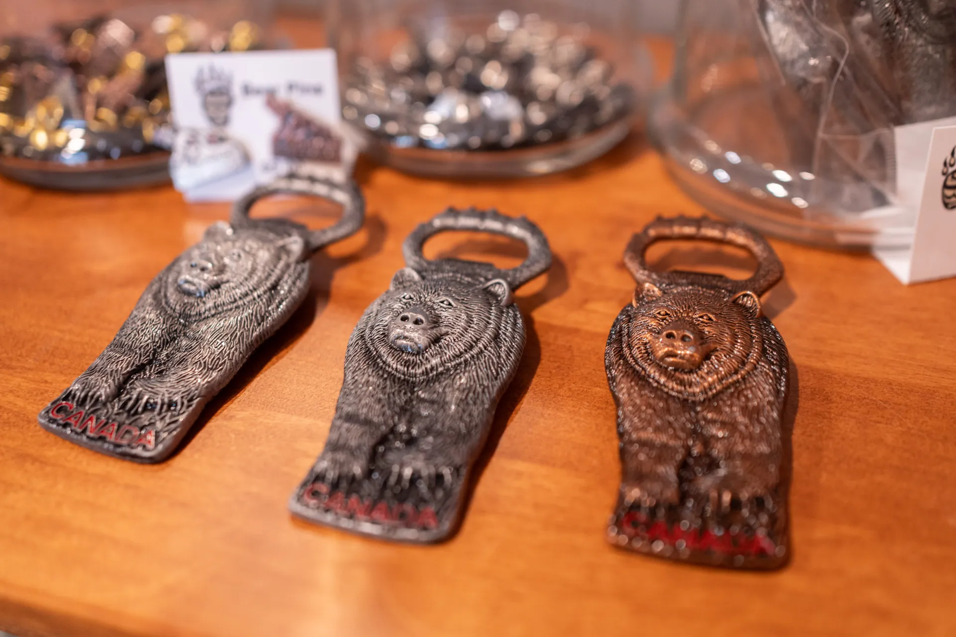Cast bear-paw bottle openers on the gift shop counter