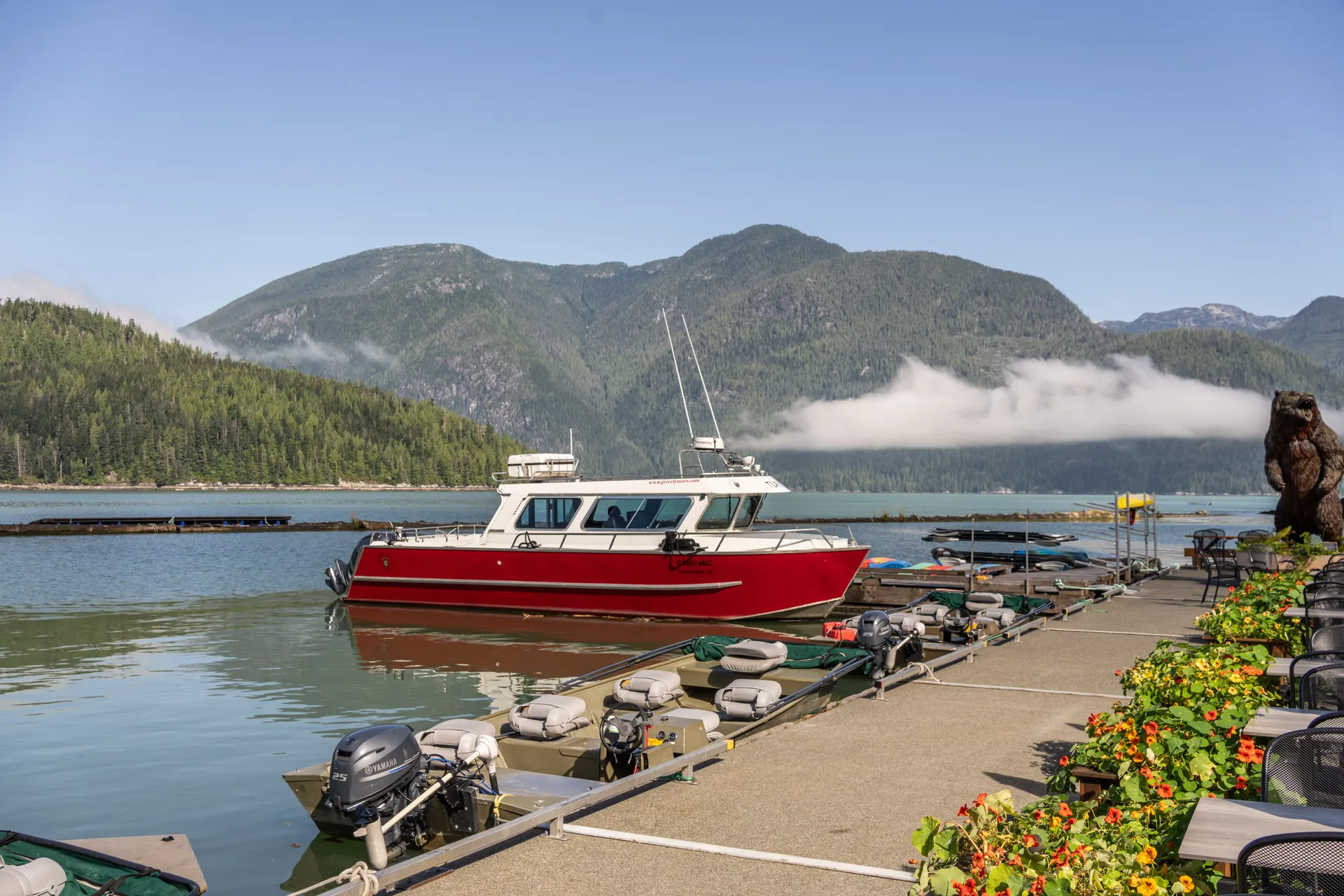 The red viewing boat at the dock with mist on the mountains behind