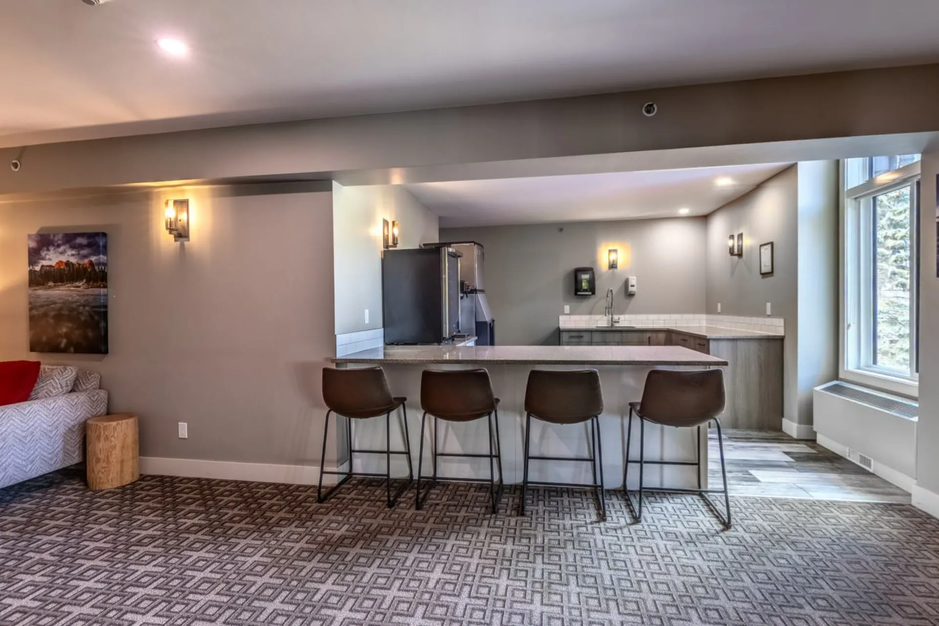 The breakfast area with a bar counter and stools off the great room