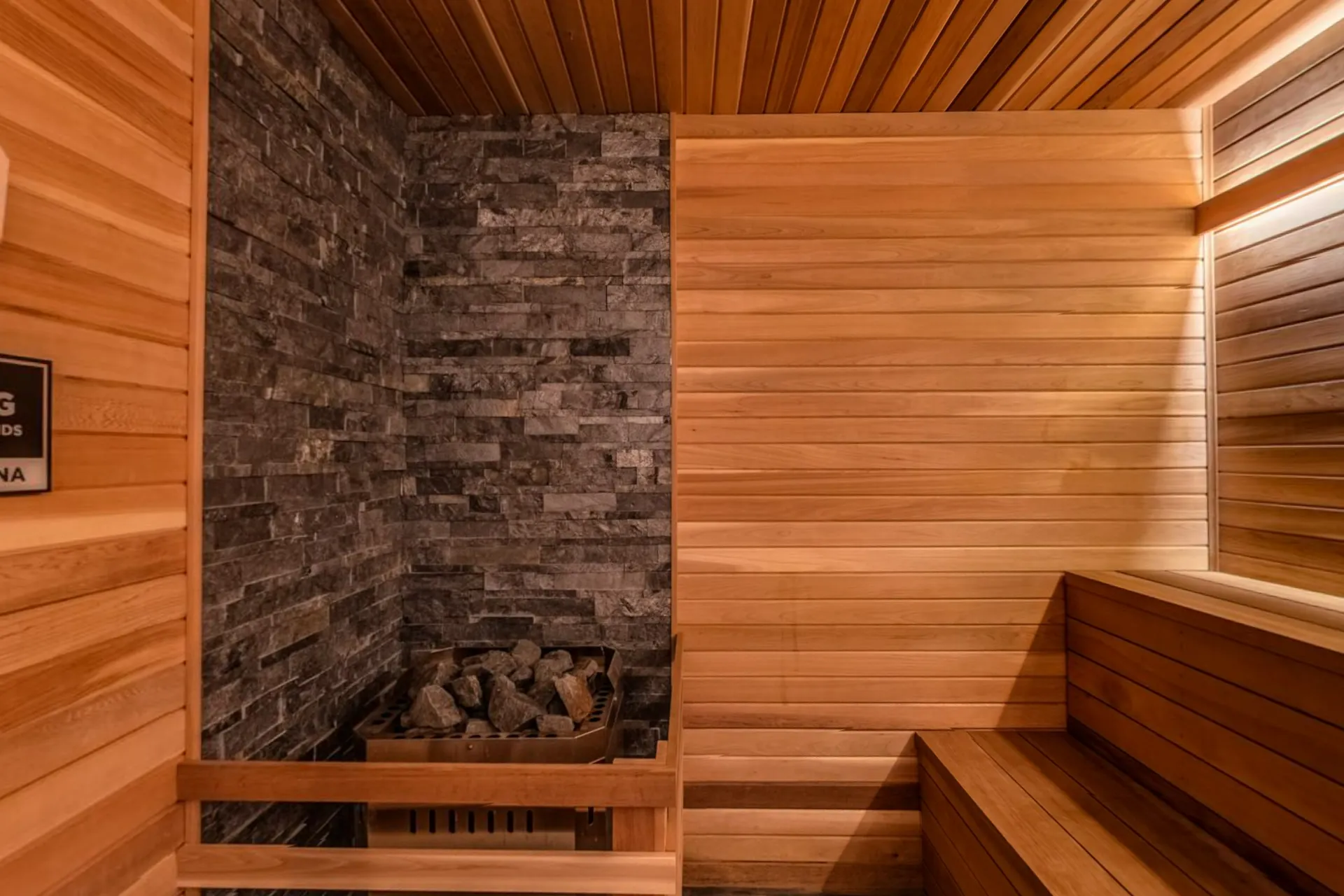The cedar dry sauna with its stone heater