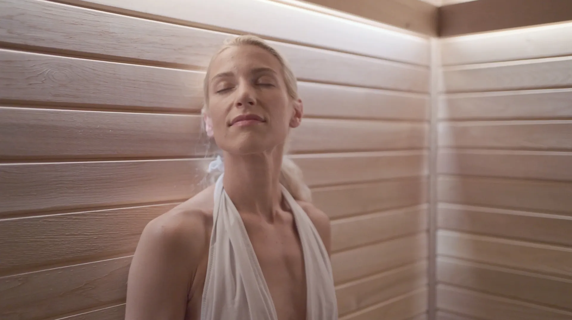 A guest in the cedar sauna, eyes closed