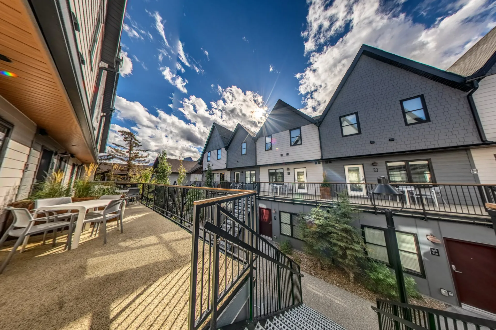 The courtyard from the upper walkway, sun and cloud over the gabled roofs