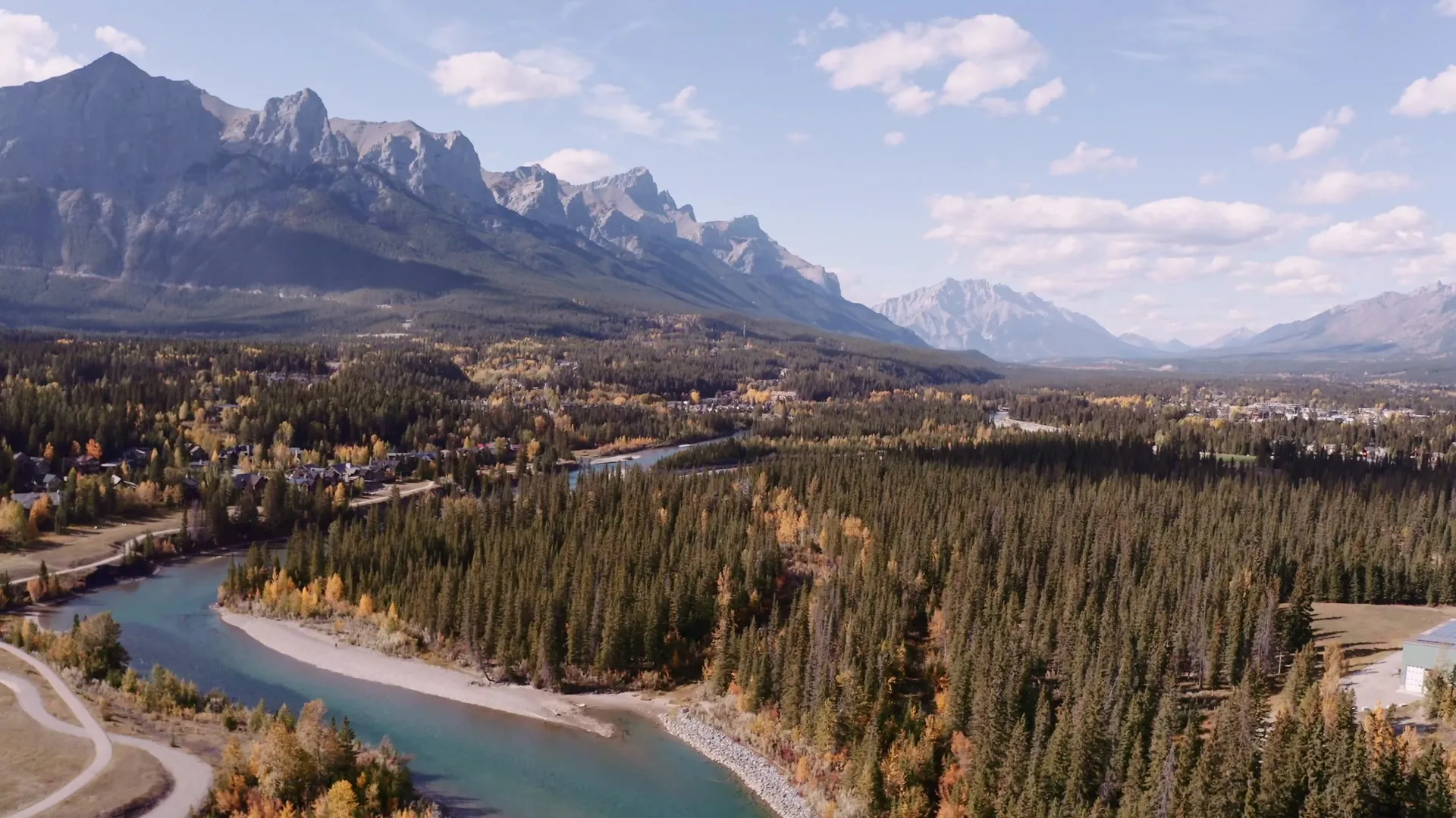 The Bow Valley from the air above Canmore, the river winding past the town with the Rockies on every side