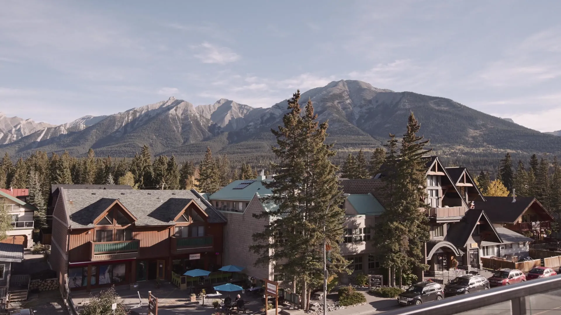 Canmore's main street from above with the Rundle range and Ha Ling Peak behind the rooftops