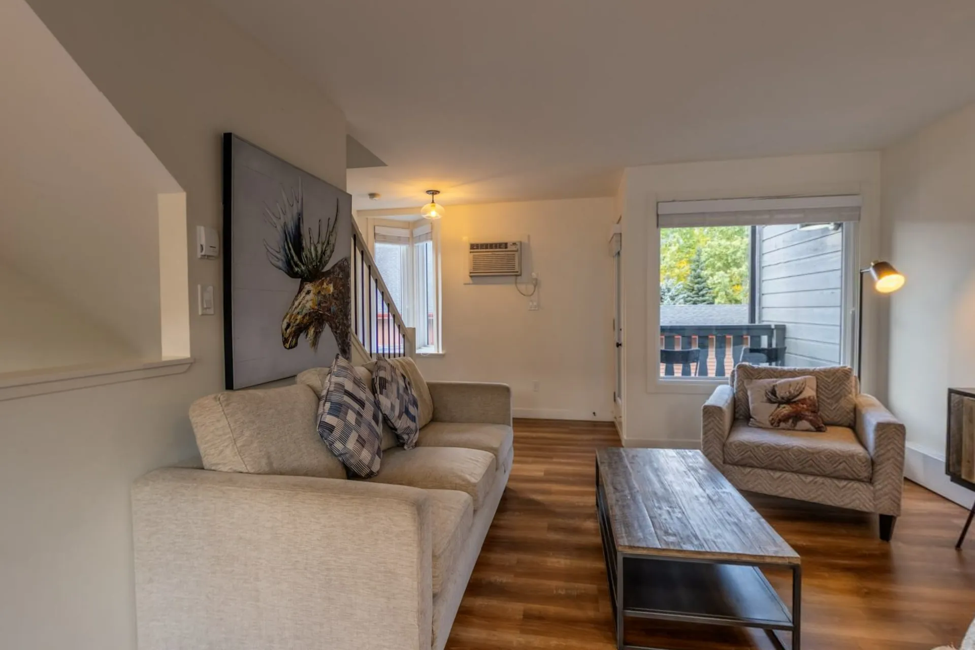 The Lamphouse Apartment's living room with a moose print above the sofa