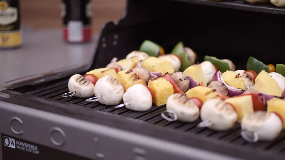 Vegetable and chicken skewers on the shared barbecue