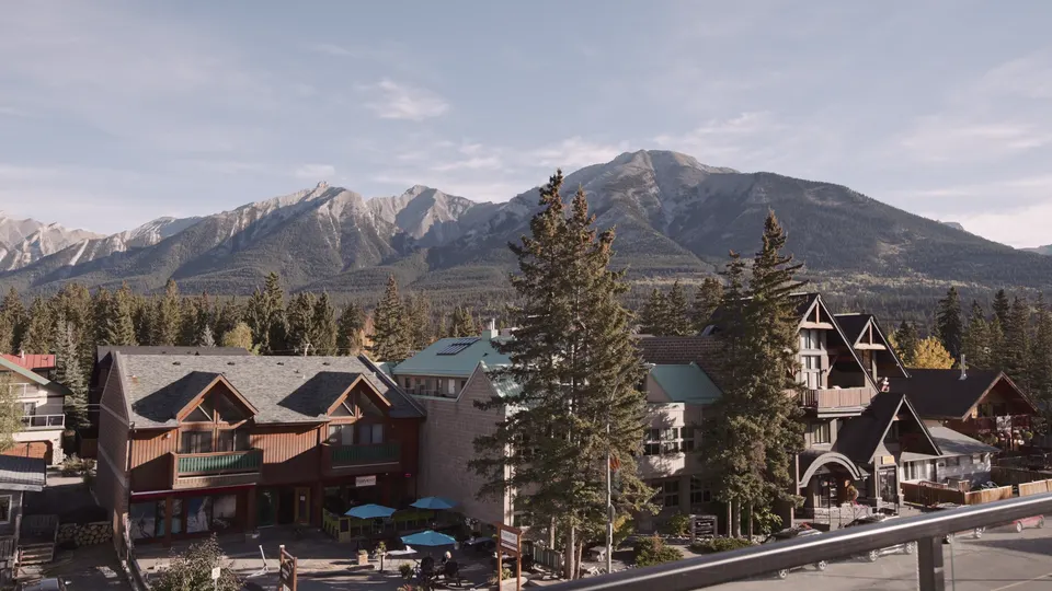 Canmore main street from above, the Rundle range and Ha Ling Peak behind the rooftops