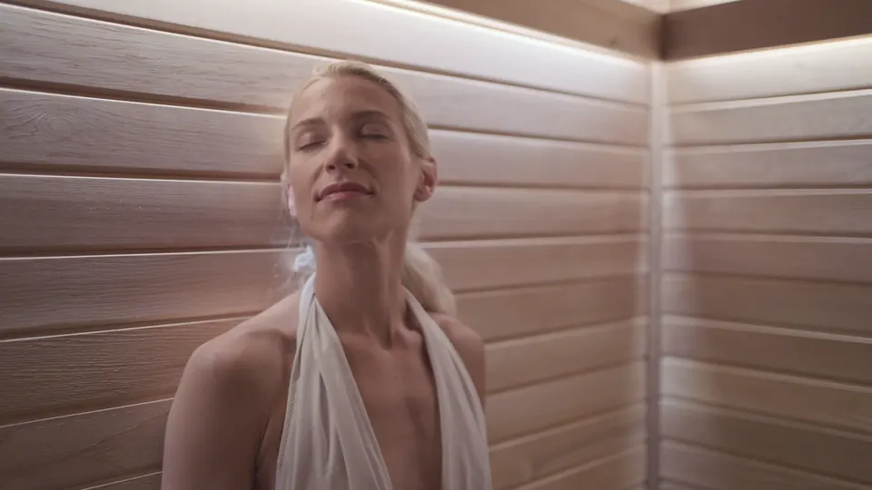 A guest in the cedar dry sauna, eyes closed