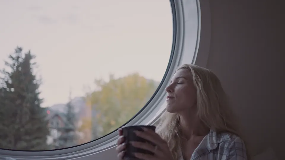 Coffee in the round window, the peaks framed behind