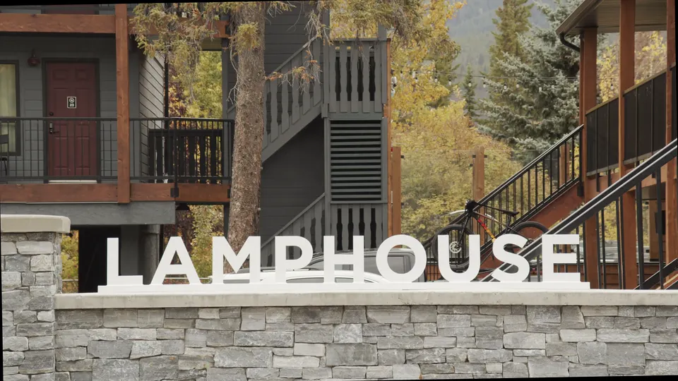 The LAMPHOUSE sign on the stone wall below the timber stairs